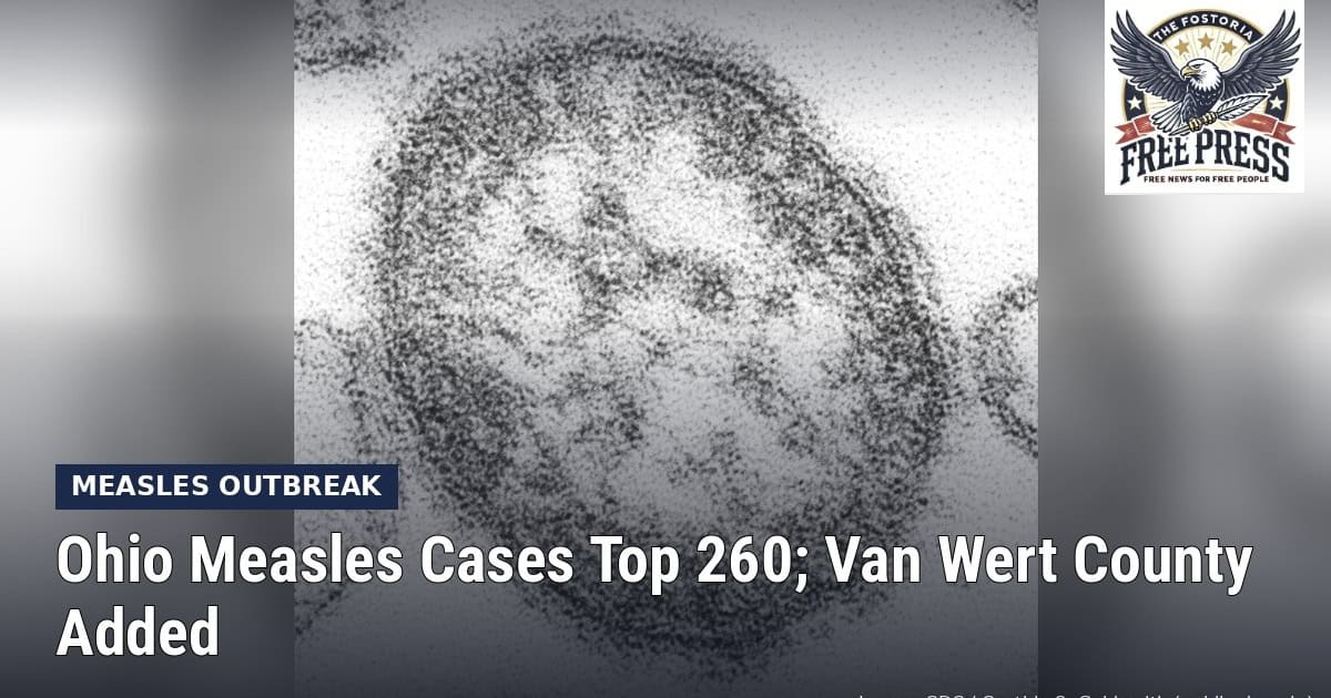 Fostoria News: Electron microscope image of a measles virus particle, with headline: Ohio Measles Cases Top 260; Van Wert County Added